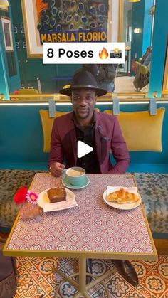 a man sitting at a table with two plates of food