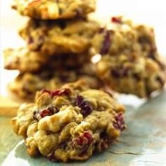 several cookies stacked on top of each other with cranberries in the middle and oatmeal toppings