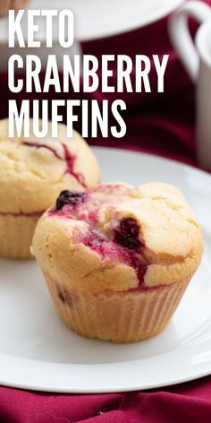 two blueberry muffins on a white plate with the title keto cranberry muffins