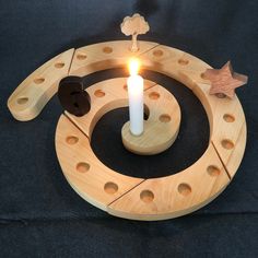 a lit candle sits in the center of a circular object with holes and circles around it