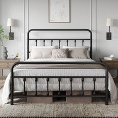 a black metal bed frame with white sheets and pillows on top of it in a bedroom