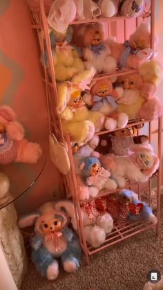 a pink shelf filled with lots of stuffed animals