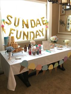 a table that has some food on it and balloons in the air above it with words reading sunday fund day