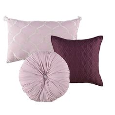 three pillows with different colors and patterns on them, one in purple and the other in white