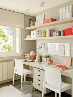 a white desk and chair in a room with bookshelves on the wall behind it