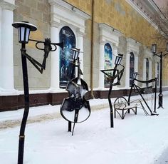 the street is covered in snow and there are many art pieces on display next to each other