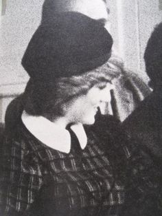 an old black and white photo of a woman wearing a hat