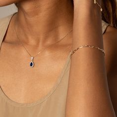 Make a statement with a teardrop-shaped sapphire pendant surrounded by a white sapphire halo. Crafted from solid 10k gold and 925 sterling silver in a two-tone style, it features a lab-created blue sapphire of 1.28 ct and a lab-created white sapphire halo of 0.38 ct.Pendant only, chain sold separately Fine Jewelry Sapphire Teardrop, Sapphire Diamond Drop Jewelry, Teardrop Sapphire Jewelry With Diamond Cut, Fine Jewelry Sapphire Teardrop Pendant, Fine Jewelry Teardrop With Halo Setting, Sapphire Teardrop Pendant Fine Jewelry, Sapphire Teardrop Pendant Jewelry, Fine Jewelry With Halo Setting In Teardrop Shape, Teardrop Sapphire Jewelry