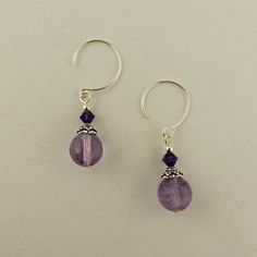 I created these earrings using Sterling silver hoops 8mm Round Faceted Genuine Amethyst 4mm Bicone Purple Velvet Amethyst  2mm round Sterling silver beads Sterling silver bead caps Check my other listings for more handcrafted jewelry as well as beads, charms and findings to create your own jewelry Insured USPS shipping in a padded envelope with a tracking number