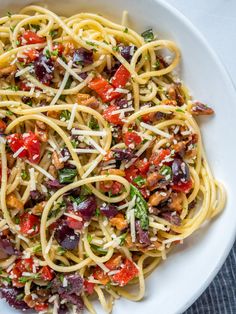 a white bowl filled with pasta and vegetables