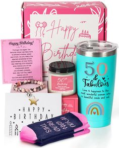 a birthday gift box with pink and blue items including a happy birthday card, candle, coffee mug, socks, and more