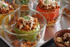 several bowls filled with food sitting on top of a table