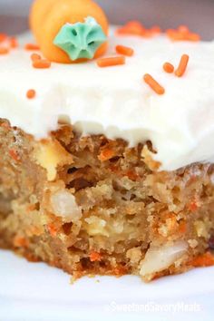 a piece of carrot cake with frosting and sprinkles