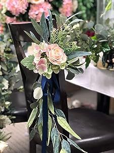 a bouquet of flowers sitting on top of a wooden chair