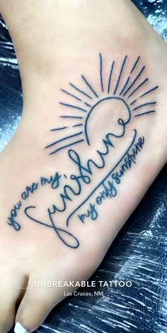 a foot tattoo with the words you are my sunshine