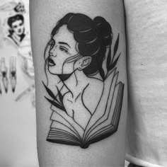 a woman with a book tattoo on her arm