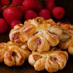 several pastries stacked on top of each other with strawberries in the background