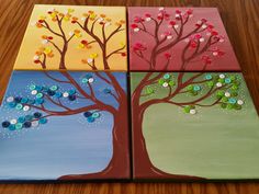 three painted trees with buttons on them