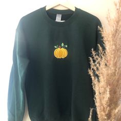 This sweater is embroidered in house to order, it makes the perfect accessory for pumpkin picking or even for a halloween party. The sweater comes in various colours and sizes with the design remaining the same colour on all. The sweatshirt is 50% Cotton 50% Polyester and is 279g/m²  offering warmth and comfort. The available colours are: Sand, White, Forest green, Antique Red or Grey The sizes available are:  Size:                   S            M             L           XL  XXL  3XL  4XL Chest (to fit):34/3638/4042/4446/4850/5254/5658/60 If you have any questions, please feel free to drop me a message Fall Sweatshirt With Embroidered Graphics, Fall Embroidered Logo Long Sleeve Hoodie, Fall Hoodie With Embroidered Logo And Long Sleeves, Fall Long Sleeve Hoodie With Embroidered Logo, Fall Long Sleeve Sweatshirt With Custom Embroidery, Fall Embroidered Cotton Hoodie, Green Embroidered Fall Hoodie, Green Fall Sweater With Embroidered Logo, Green Sweater With Embroidered Logo For Fall