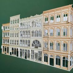 a paper model of a building with windows and balconies on the top floor