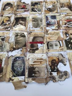 altered photograph collages are displayed on a white tablecloth covered with torn paper