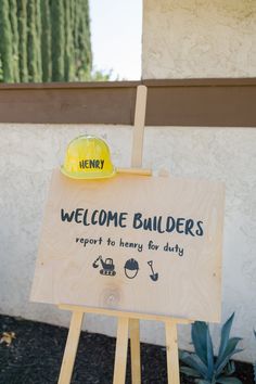 a wooden sign with a yellow hard hat on top that says, welcome builder report to honey for duty