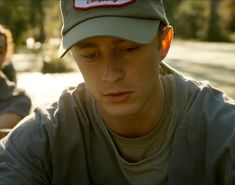 a man wearing a hat sitting next to another man