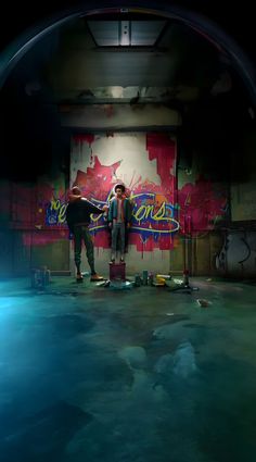 two people standing in an empty room with graffiti on the walls and flooring around them