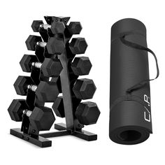 a black gym set with dumbs and a yoga mat next to it on a white background