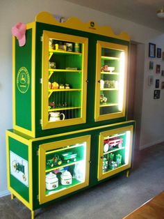 a large green and yellow cabinet with shelves