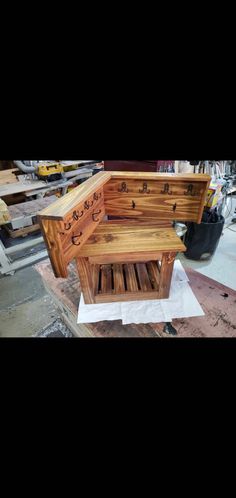 a wooden bench sitting on top of a piece of wood