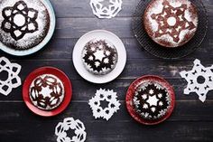 there are several cakes on the table with snowflakes around them and one is chocolate