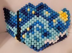 a bunch of beads are arranged in the shape of a fish