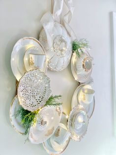 a wreath made out of plates and dishes