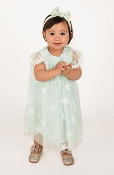 Get baby ready to show off in this floaty tulle dress patterned in three-dimensional star appliqués and framed by sheer lace-trimmed sleeves. Cotton lining 95% nylon, 5% polyester Hand wash, line dry Imported Dress-up Tulle Dresses With Lace Patchwork, Tulle Dress With Lace Patchwork For Dress-up, Short Sleeve Lace Dress With Sheer Sleeves, Short Sleeve Tulle Dress With Floral Applique, Short Sleeve Tulle Dress With Lace Trim, Green Tulle Dress With Short Sleeves, Whimsical Dresses For Baptism In Spring, Whimsical Dresses For Spring Baptism, Cute Party Dress With Lace Trim