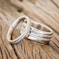 two wedding rings sitting on top of each other