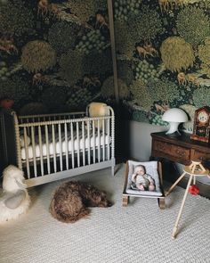 a baby's room with a crib and pictures on the wall next to it