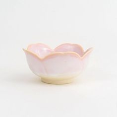 a white and pink bowl sitting on top of a table