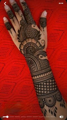 a woman's hand is decorated with hennap and intricate designs on it