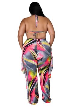 the back of a woman's body wearing a multicolored print jumpsuit