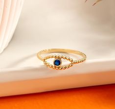 ------}{ 10K, 14K, 18K SOLID GOLD EVIL EYE RING }{------ 1OK, 14K, 18K Solid Gold Evil Eye Ring, The Ring Details: 💍 Gemstone: Cubic Zirconia 💍 10K-14K-18K Yellow, Rose, White Gold 💍 Gold Colour Options; Yellow Gold, White Gold, Rose Gold 🧿 Introducing our exquisite Evil Eye ring, a symbol of strength and protection crafted with the utmost care and attention to detail. This dainty yet impactful piece is designed to ward off negative energies and surround you with a shield of positivity. 💙 Available in your choice of 10K, 14K, or 18K gold, this ring offers versatility and luxury in equal measure.  Complemented by three stunning gold options - Yellow, White, or Rose - this ring is a testament to both style and substance. 🧿Whether you're treating yourself or surprising a loved one, this Gold Evil Eye Jewelry, Evil Eye Ring Gold, Protection Ring, Evil Eye Ring, Rose Gold Band, Eye Ring, Gold Colour, Evil Eye Jewelry, Eye Jewelry