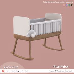 the baby crib is made from wood and has a white blanket on it's side