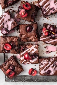 brownies with cherries and chocolate frosting on a tray