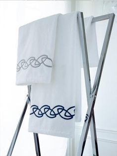 two towels are hanging on a towel rack