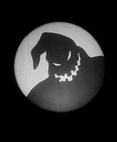 a black and white photo of a dog's head in the dark with its eyes closed