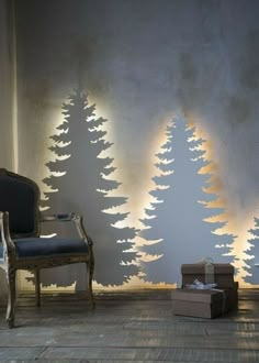 a living room with a couch, chair and christmas trees on the wall