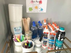 there are many crafting supplies on the shelf in front of the sign that says paint