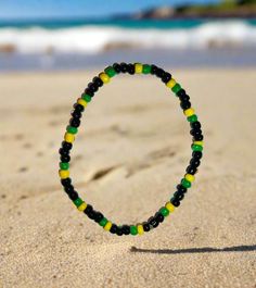 Represent your Island in style with our Jamaican  Beaded Bracelet Available in:   -Trinidad and Tobago -Barbados -St Vincent & Grenadines  -St Lucia  -Grenada  -Rastafarian  Available in 6 Sizes Tiny 5 - 5.5 inches  XS 6 - 6.5 inches  S 6.5 - 7 inches  M 7 - 7.5 inches  L 7.5 - 8 inches  XL 8 - 8.5 inches Materials: Glass seed beads (4mm) Includes a free jewellery bag to keep your bracelet safe. Black Beach Friendship Bracelets With Tiny Beads, Black Beaded Bracelets With Large Beads For Beach, Black Beaded Bracelets For The Beach, Green Beaded Bracelets With Black Beads As A Gift, Multicolor Beaded Bracelets With Black Beads For Beach, Black Letter Beads Bracelet For Beach, Black Bracelets With Letter Beads For Beach, Green Bracelets With Large Beads For Beach, Casual Green Jewelry With Black Beads