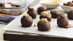 chocolate truffles with nuts and chopped walnuts on a cutting board, ready to be eaten