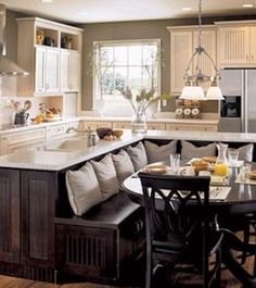 a kitchen filled with lots of counter space next to a dining room table and chairs